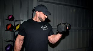 Weightlifter curling with a Hampton Dura-Bell urethane dumbbell.