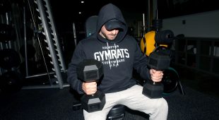 Weightlifter holding two Hampton Dura-Bell dumbbells.