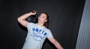 Female athlete lifting a Hampton urethane kettlebell.