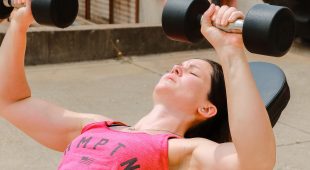 Hampton Elite Athlete Jesse Labreck doing a bench press using Hampton Dura-Pro dumbbells.