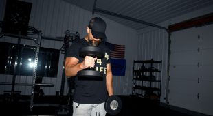 An athlete performing a vertical lift with a Hampton Gel-Grip dumbbell