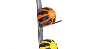 Vertical rack of heros strength medicine balls in assorted colors weighing 4 pounds, 6 pounds, 8 pounds, 10 pounds, and 12 pounds.