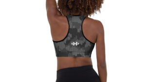 African American woman with short natural hair, back facing camera, shades of gray camo racerback sports bra with black leggings