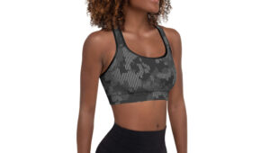 African American woman with short natural hair, side facing camera, shades of gray camo racerback sports bra with black leggings