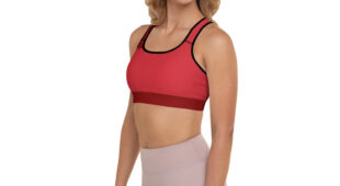 blonde woman facing front with red sports bra and muted mauve leggings