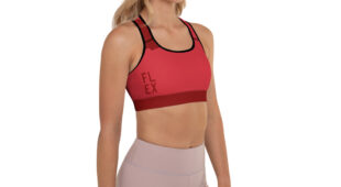 blonde woman facing front with red sports bra and muted mauve leggings