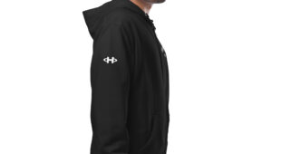 male modeling black zip up hoodie with white hampton logo on the sleeve