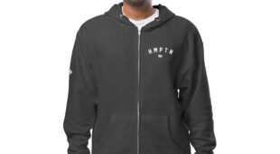 male modeling charcoal zip up hoodie with white hampton logo on the chest