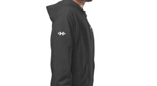 male modeling charcoal zip up hoodie with white hampton logo on the sleeve