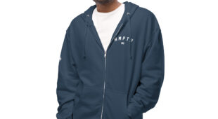 male modeling navy zip up hoodie with white hampton logo on the chest